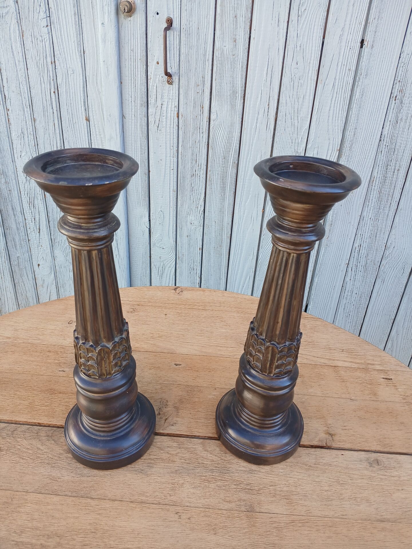 2 carved wooden candlesticks