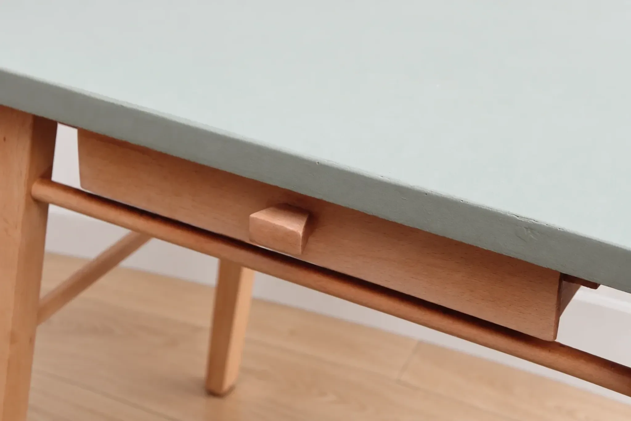 Small vintage children's desk attributed to Baumann – natural wood and lizard green top.