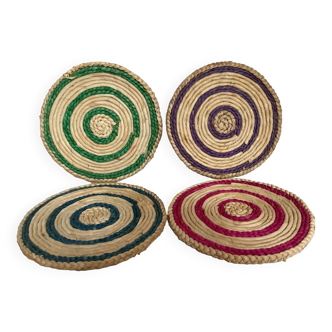 Four woven straw trivets
