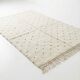 Ecru Moroccan rug with black dots.