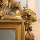 Eclectic antique mirror in carved and gilded wood, Italy, 19th century.