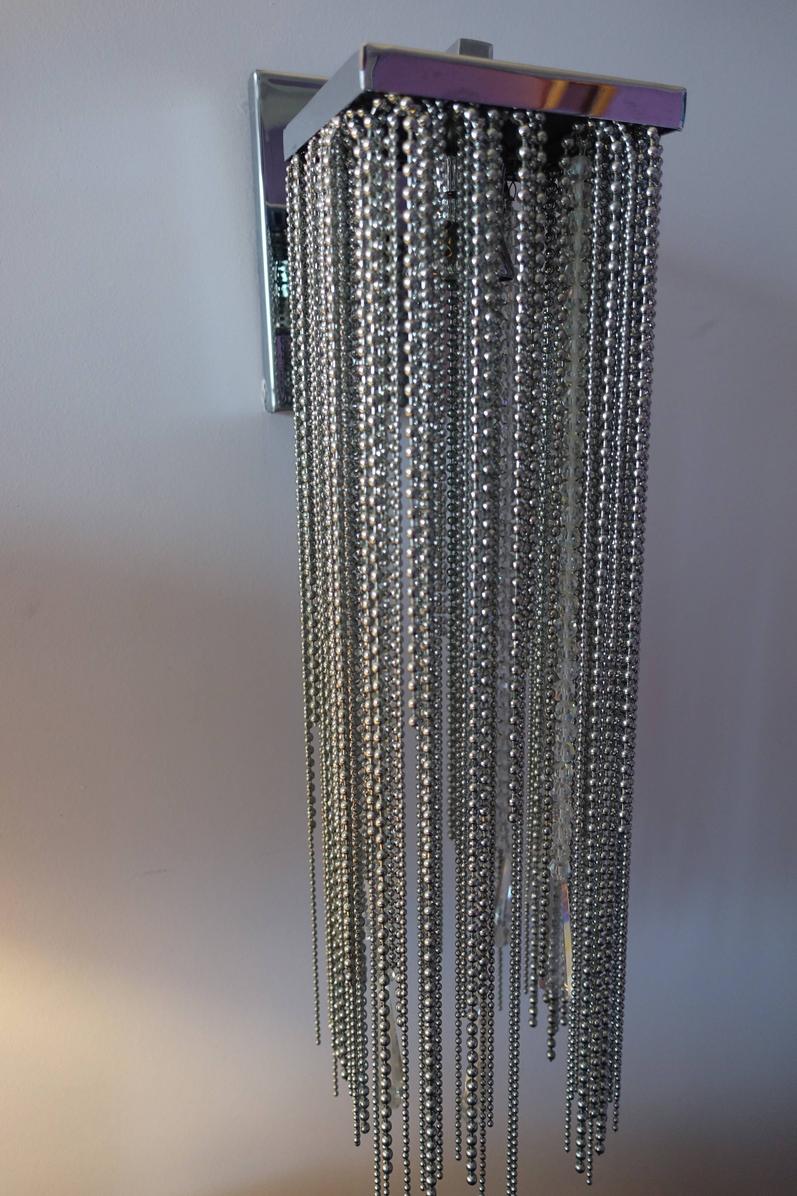 Swarovski wall lamp in silver-plated metal with crystal pendants.