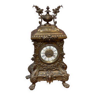Brass clock, dragon and vine motifs.