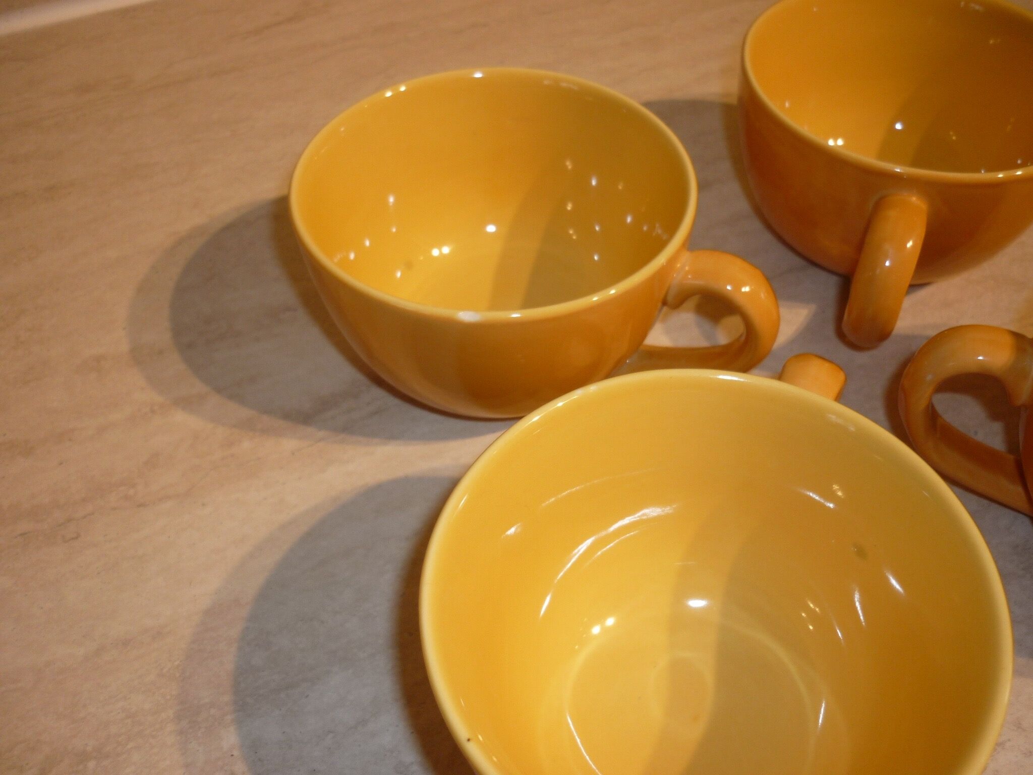 4 yellow and orange ceramic cups
