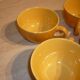 4 yellow and orange ceramic cups