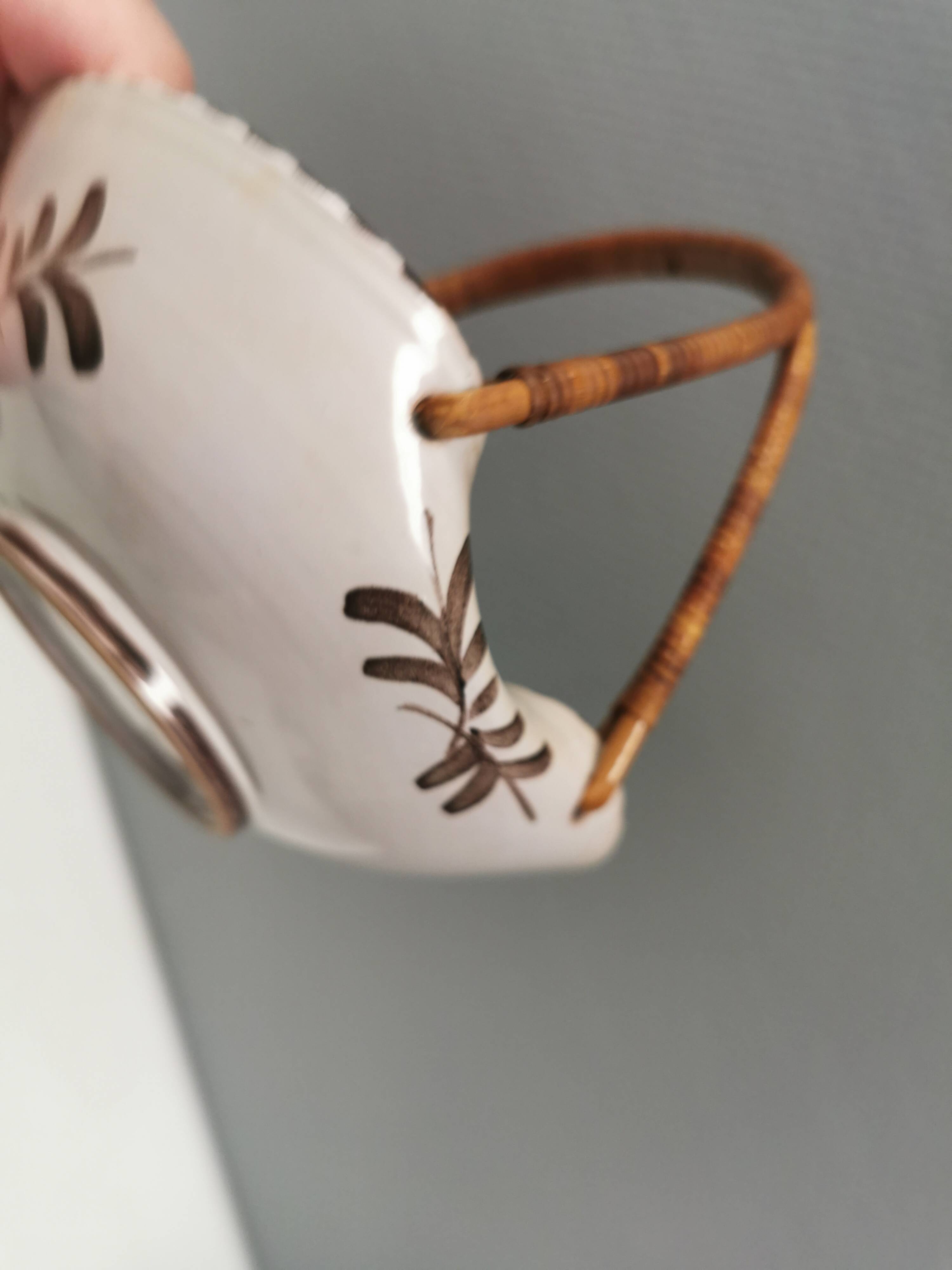 Beautiful small painted ceramic basket with woven handle