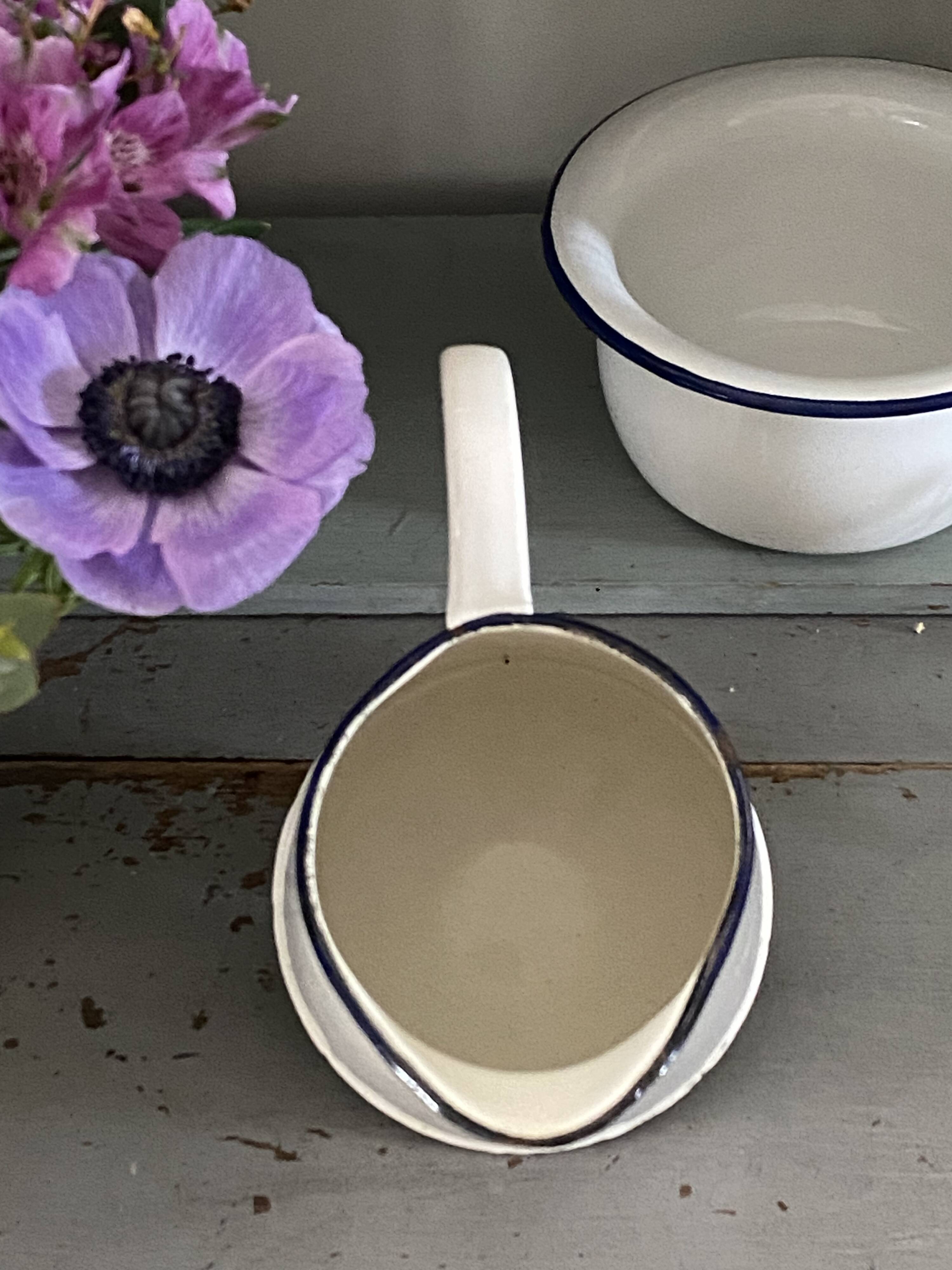 Old white enameled pitcher