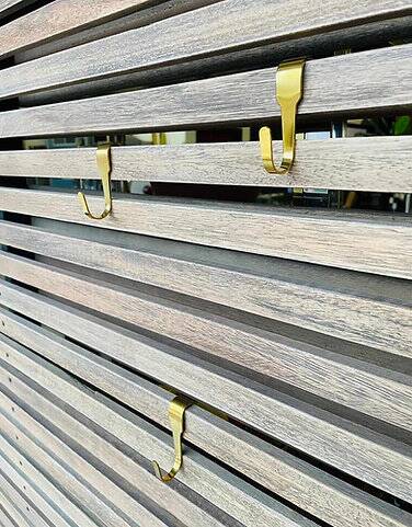 Slatted wood panel room divider or slatted coat rack with 10 mobile hooks