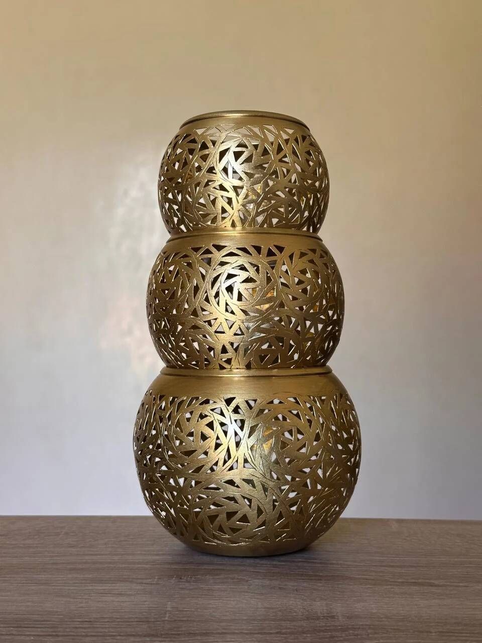 Set of 3 handmade brass candle holders with an openwork pattern.