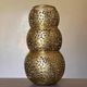 Set of 3 handmade brass candle holders with an openwork pattern.