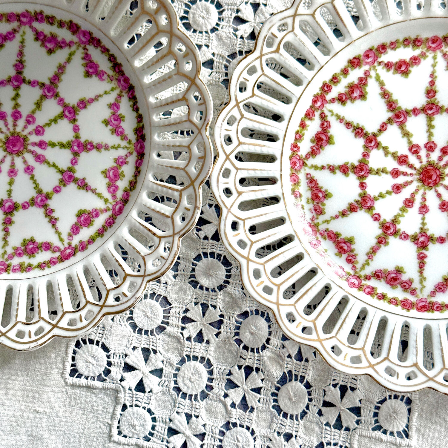 Pair of openwork porcelain plates decorated with roses