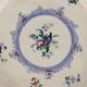 Antique earthenware plates with floral decoration from the 19th century.