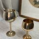 Green stemmed, brass chalices