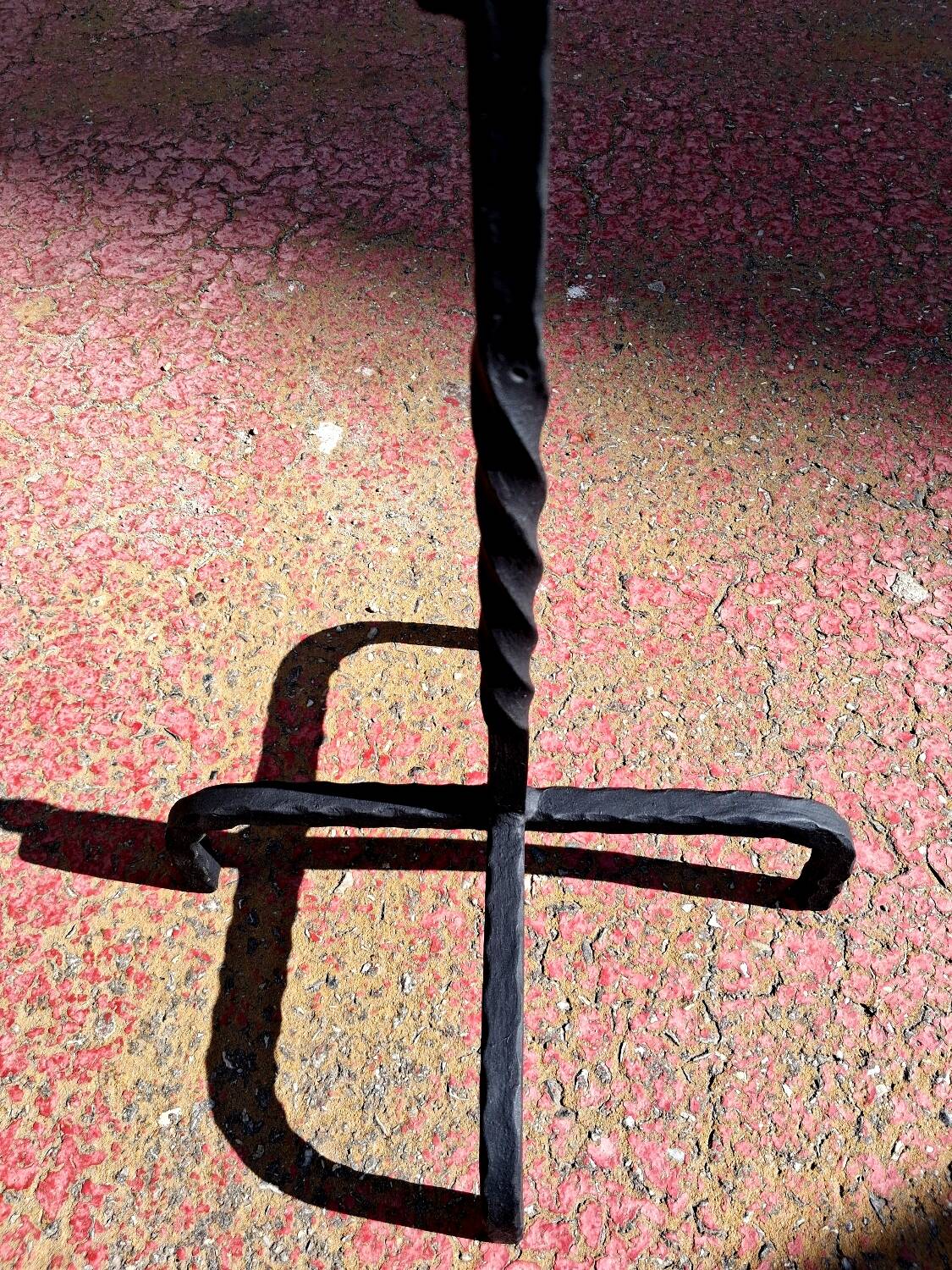 Old ashtray on twisted hammered wrought iron legs, vintage decor.