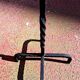 Old ashtray on twisted hammered wrought iron legs, vintage decor.