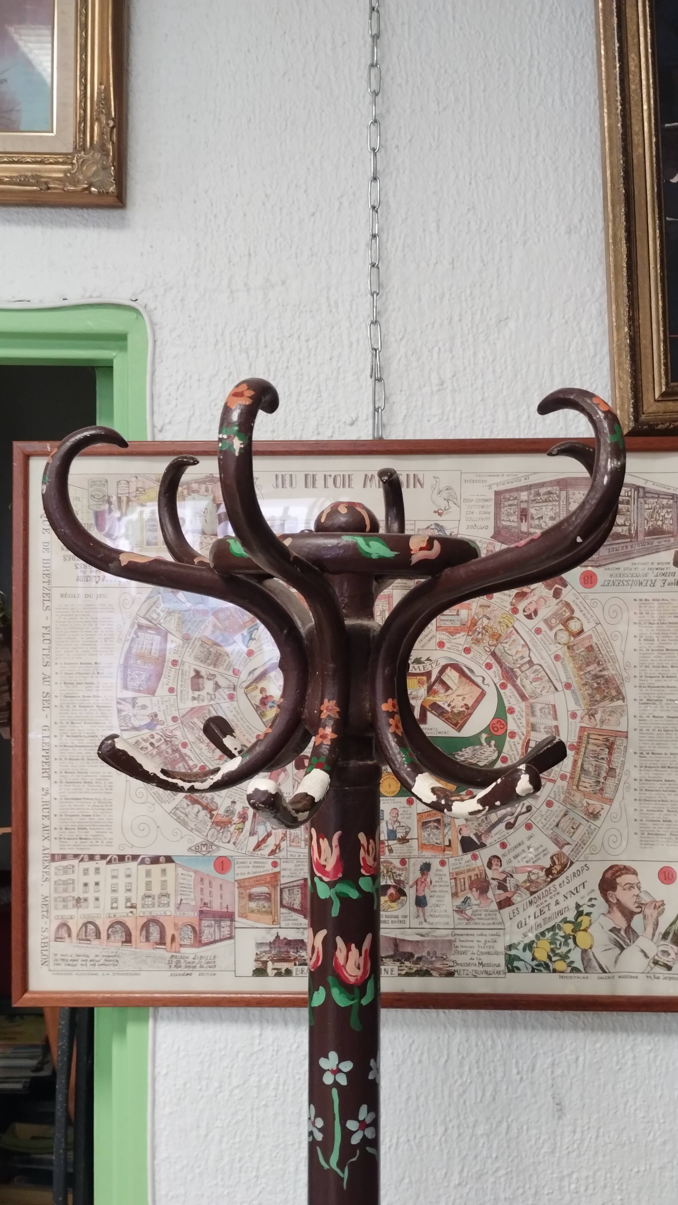 Wooden parrot coat rack with painted floral decoration.