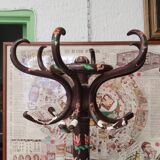 Wooden parrot coat rack with painted floral decoration.