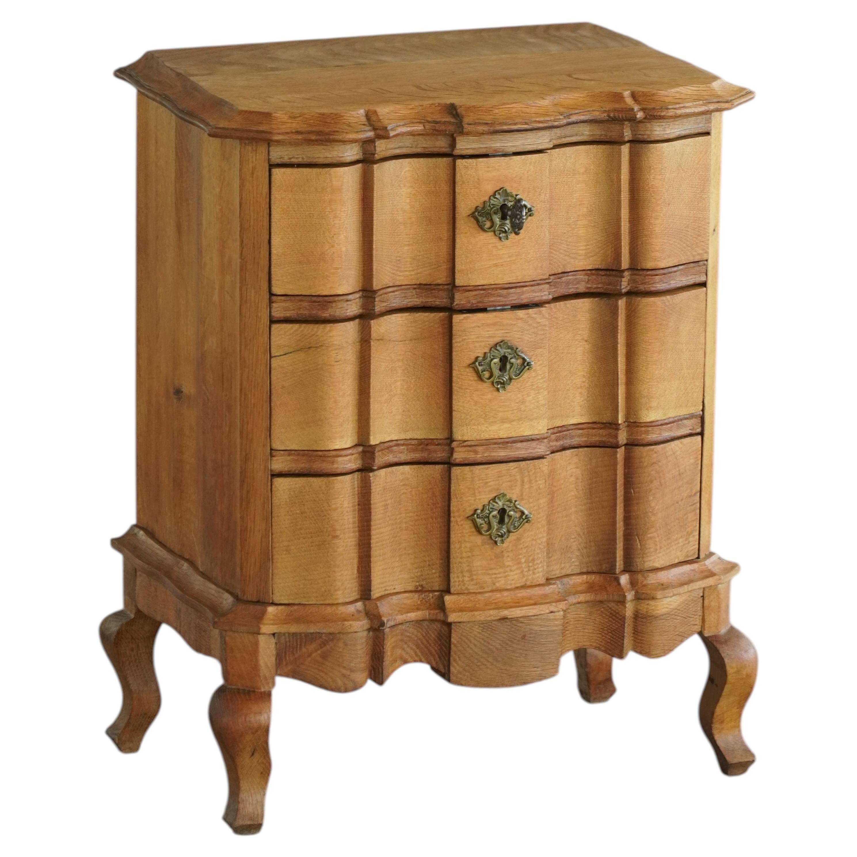Danish neo-baroque oak commode with three drawers, featuring brass fittings, 1940s.
