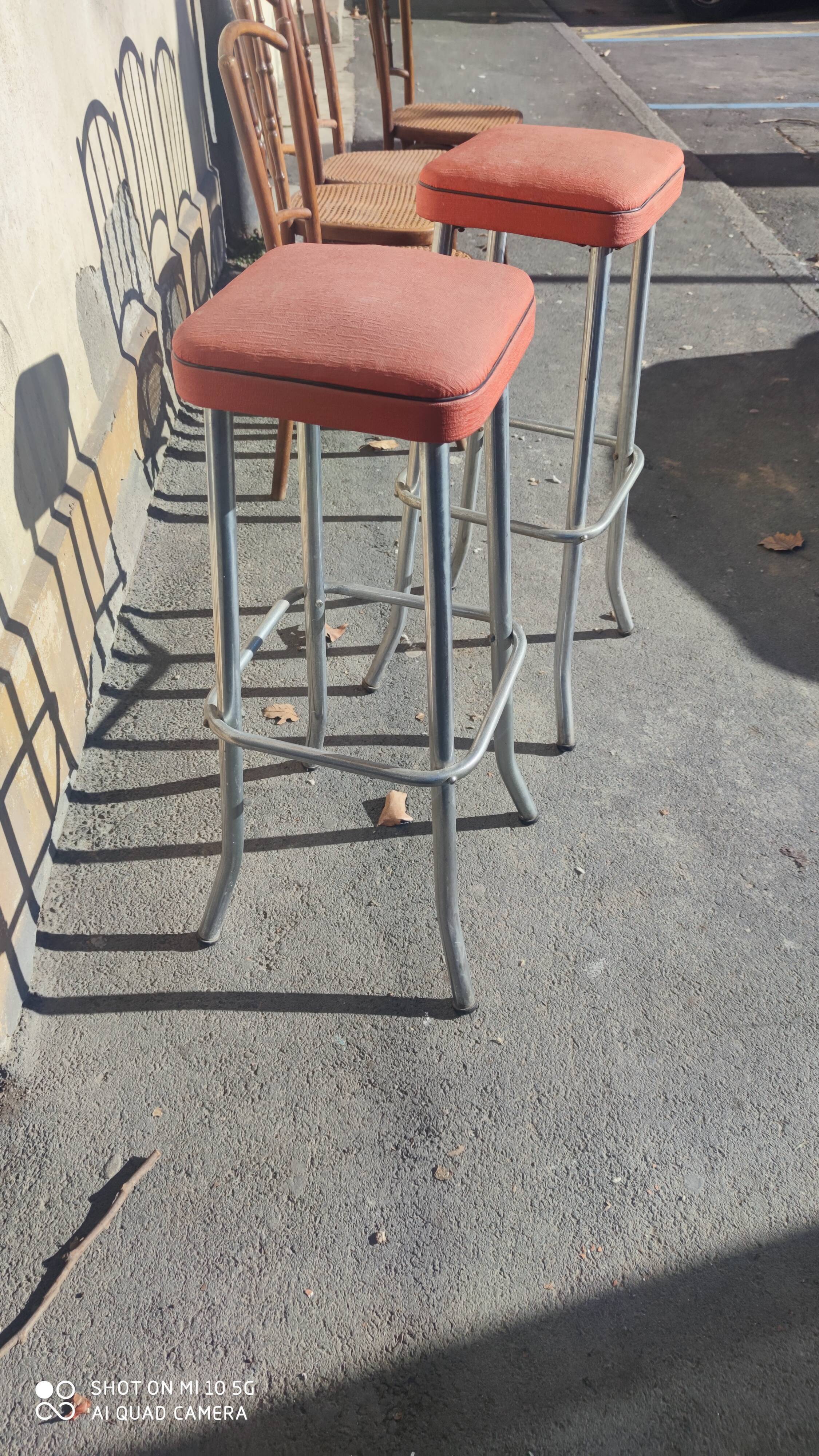Pair of aluminum bar stools with orange and black seats