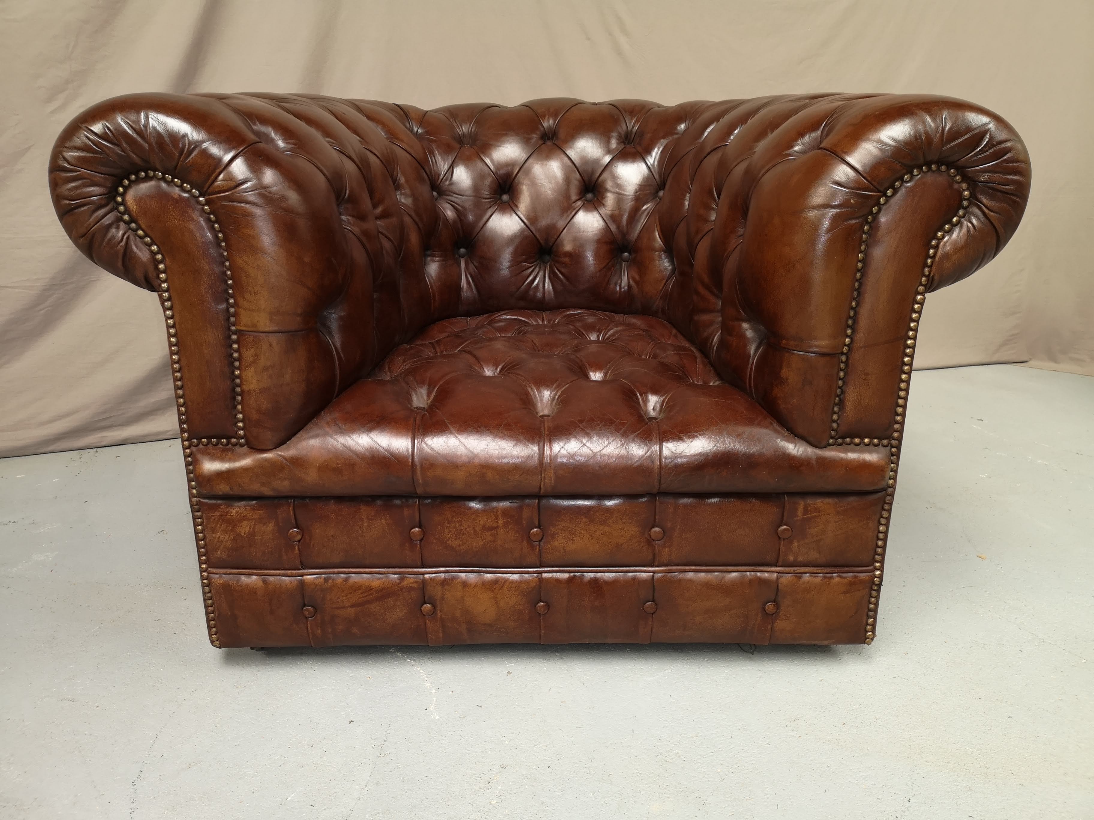 Padded Brown chesterfield armchair