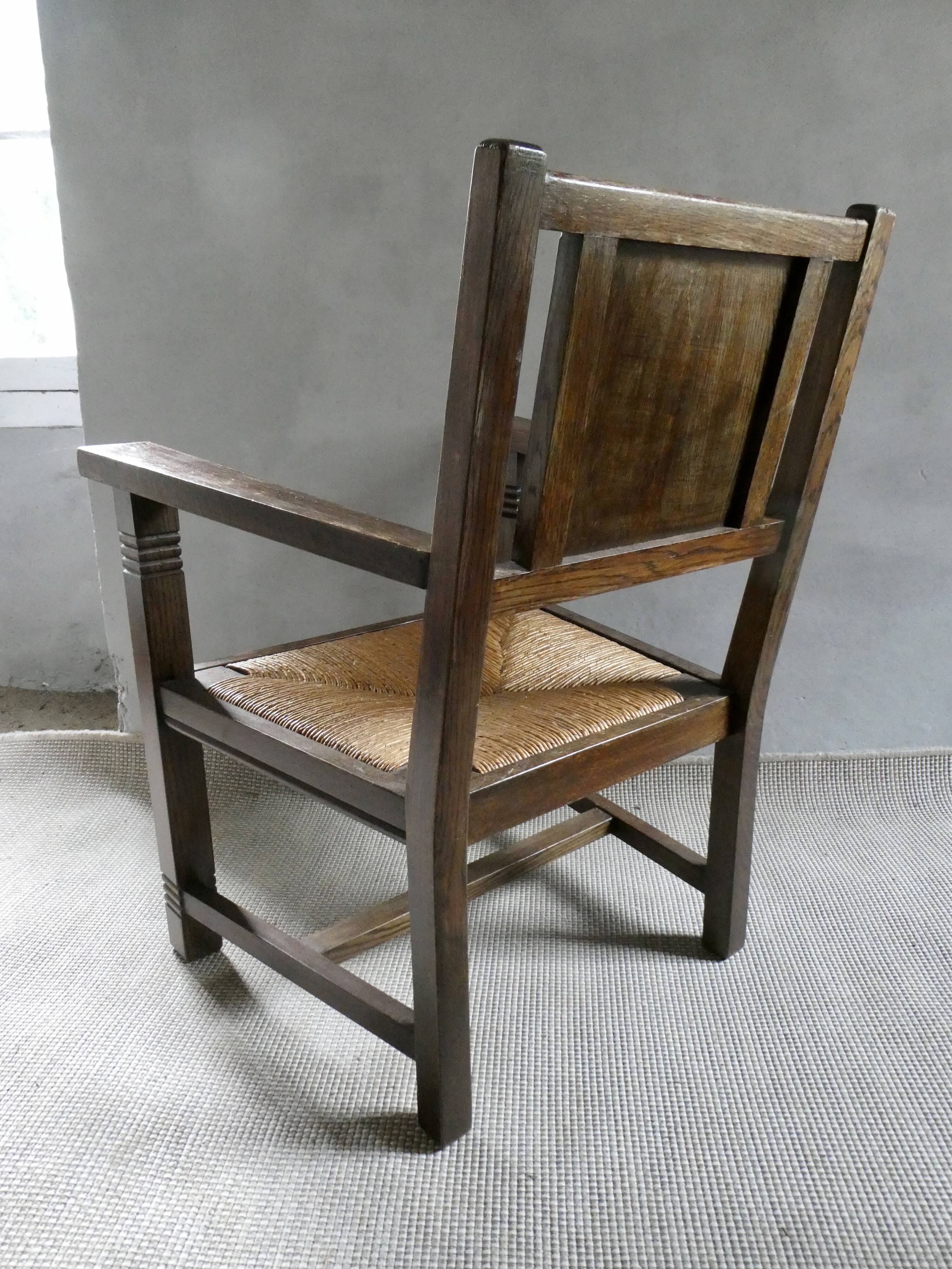 Armchair in carved solid wood with straw seat
