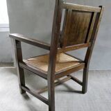 Armchair in carved solid wood with straw seat