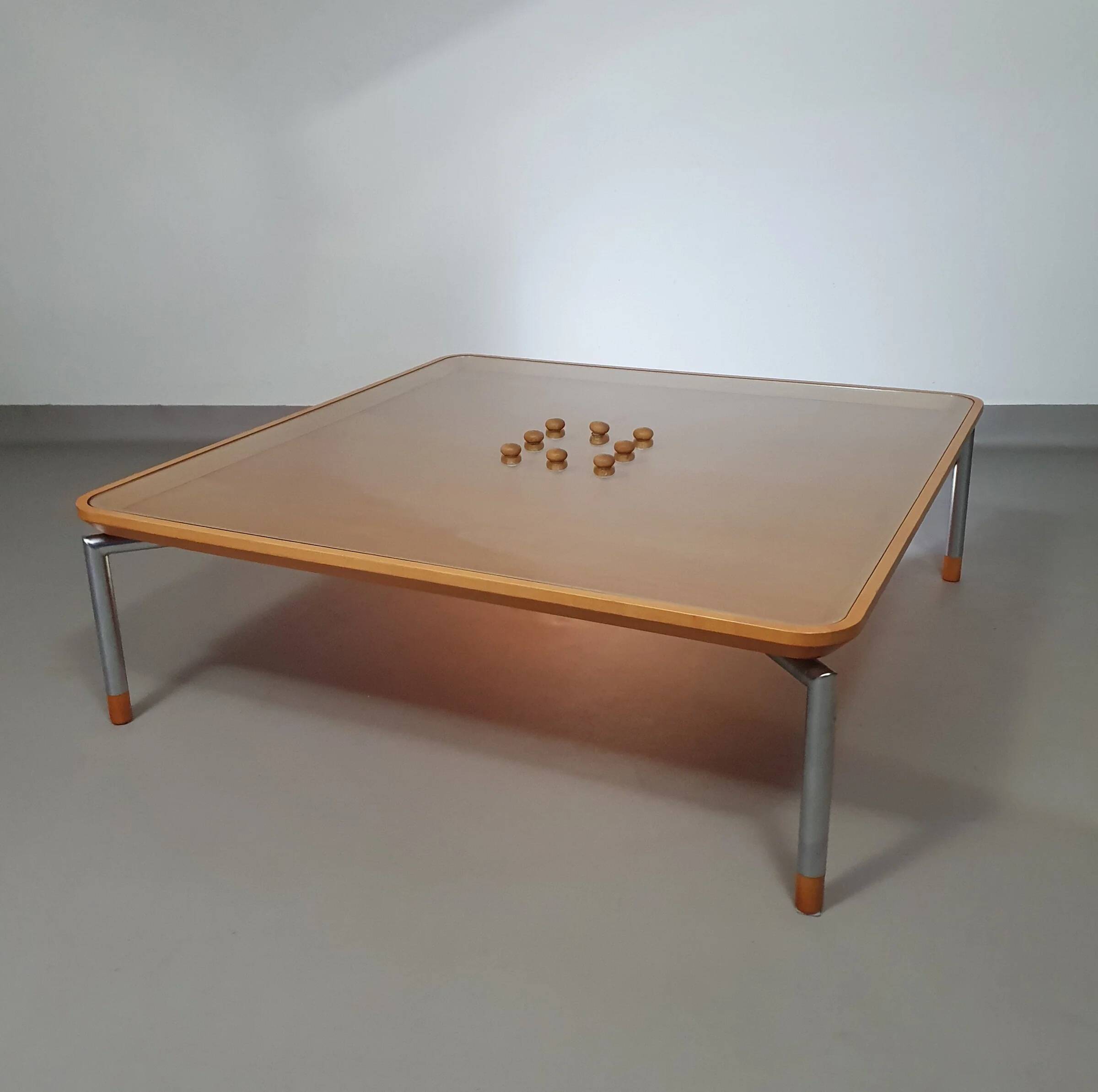 Rare coffee table 110 x 110 x height 35 cm with 8 flange wooden / cork caps in the glass top.