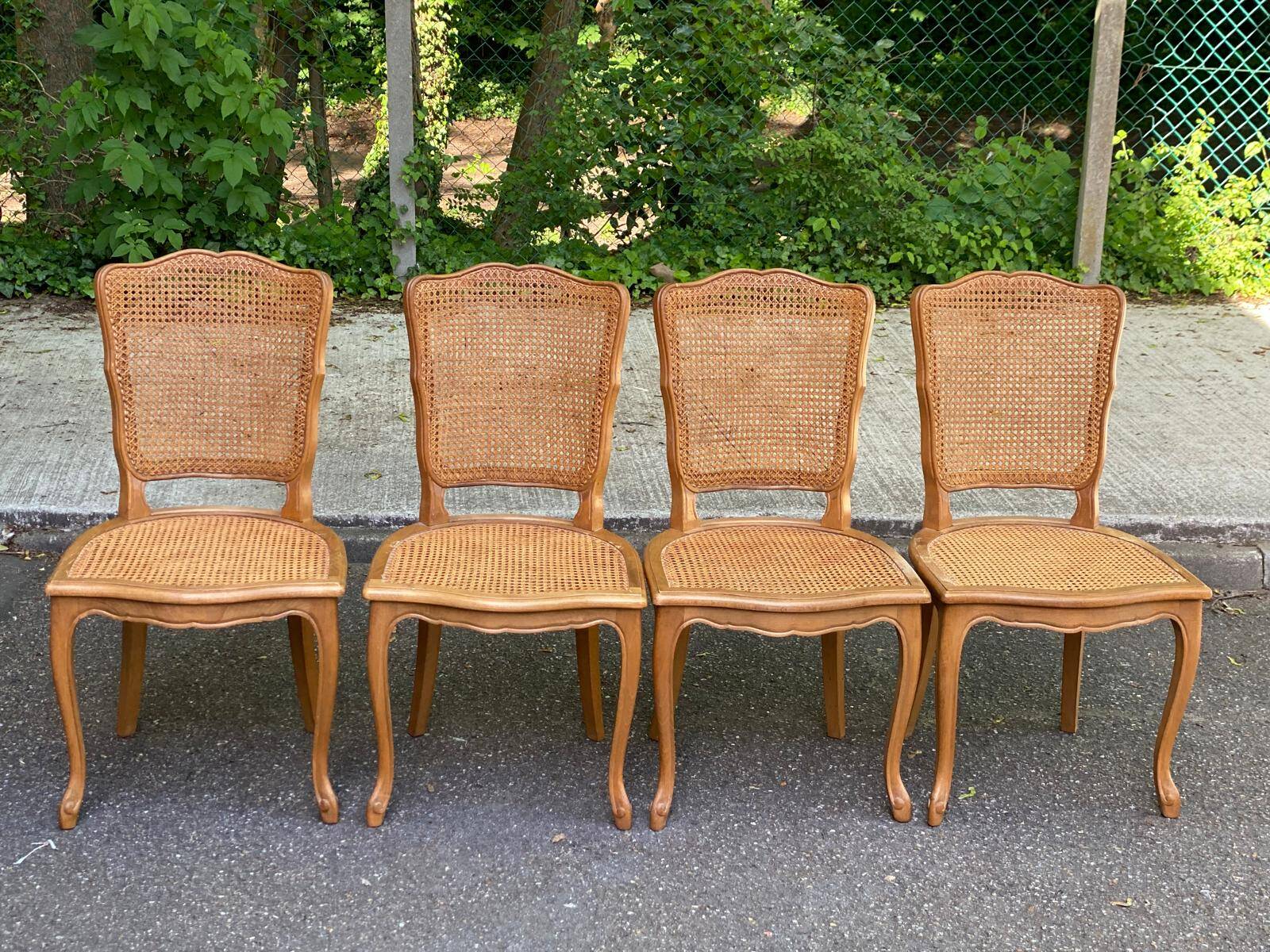 4 Louis XV dining chairs in light solid oak with caning.
