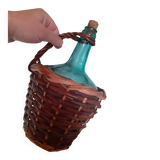 Glass bottle in its wicker dress