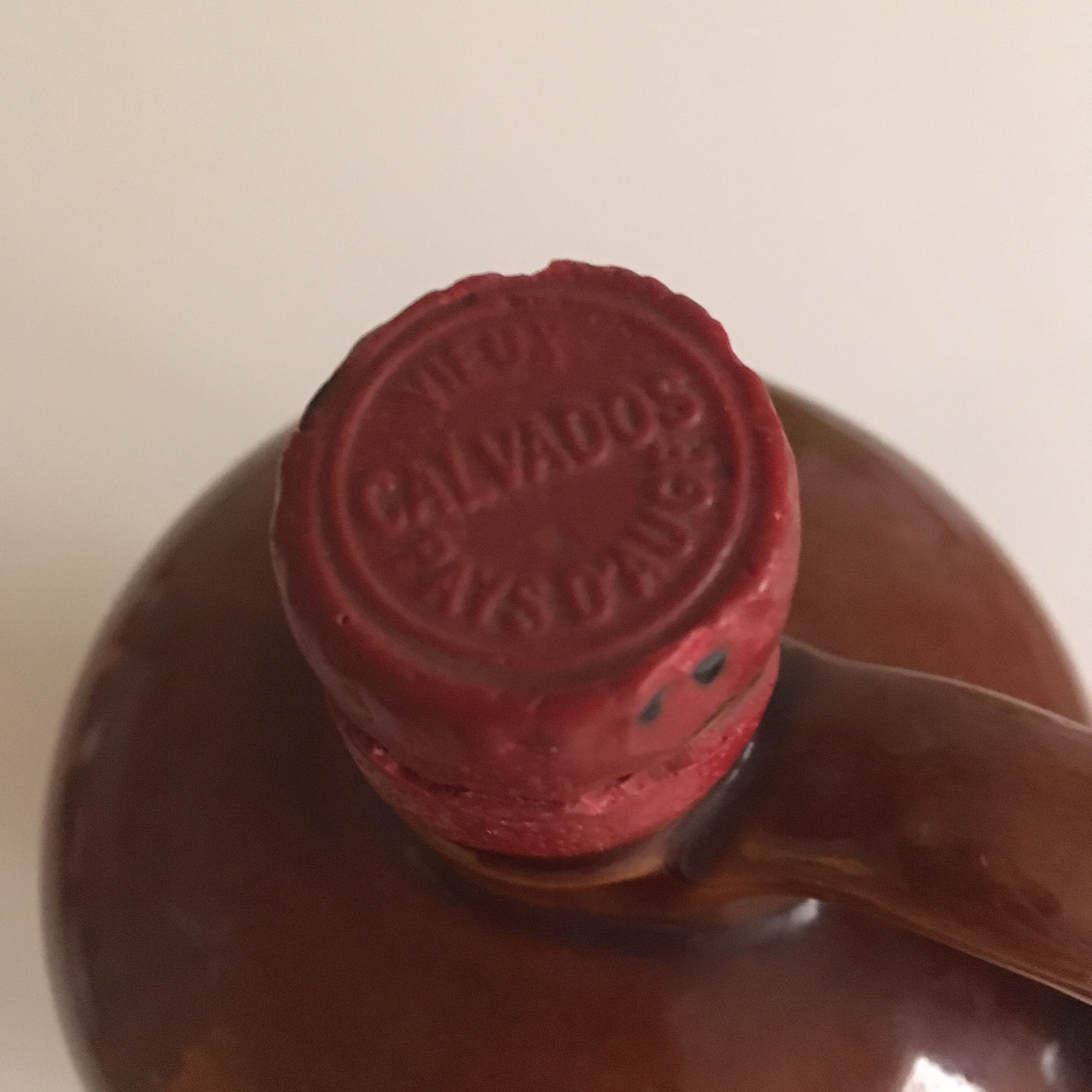 Old bottle of Calvados in sandstone