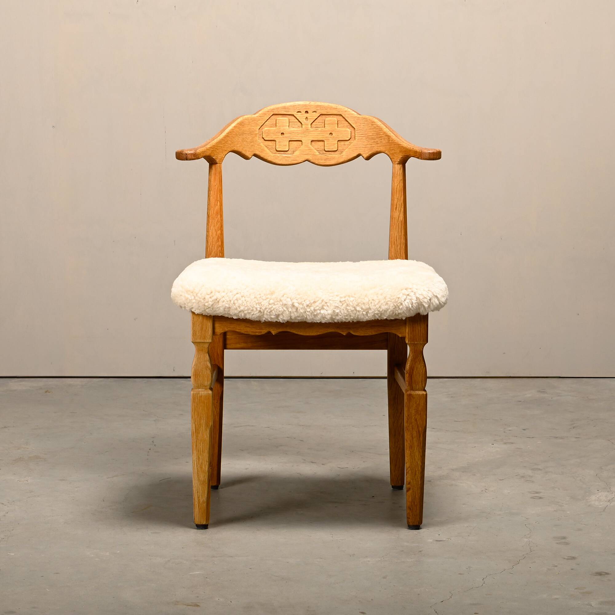 Henning Kjærnulf dining chairs set in Oak and Sheepskin, Denmark, 1960s