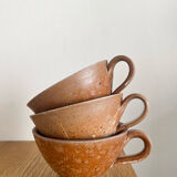 Three antique stoneware cups