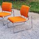 Pair of designer armchairs in orange fabrics and chrome tubes from the 70s