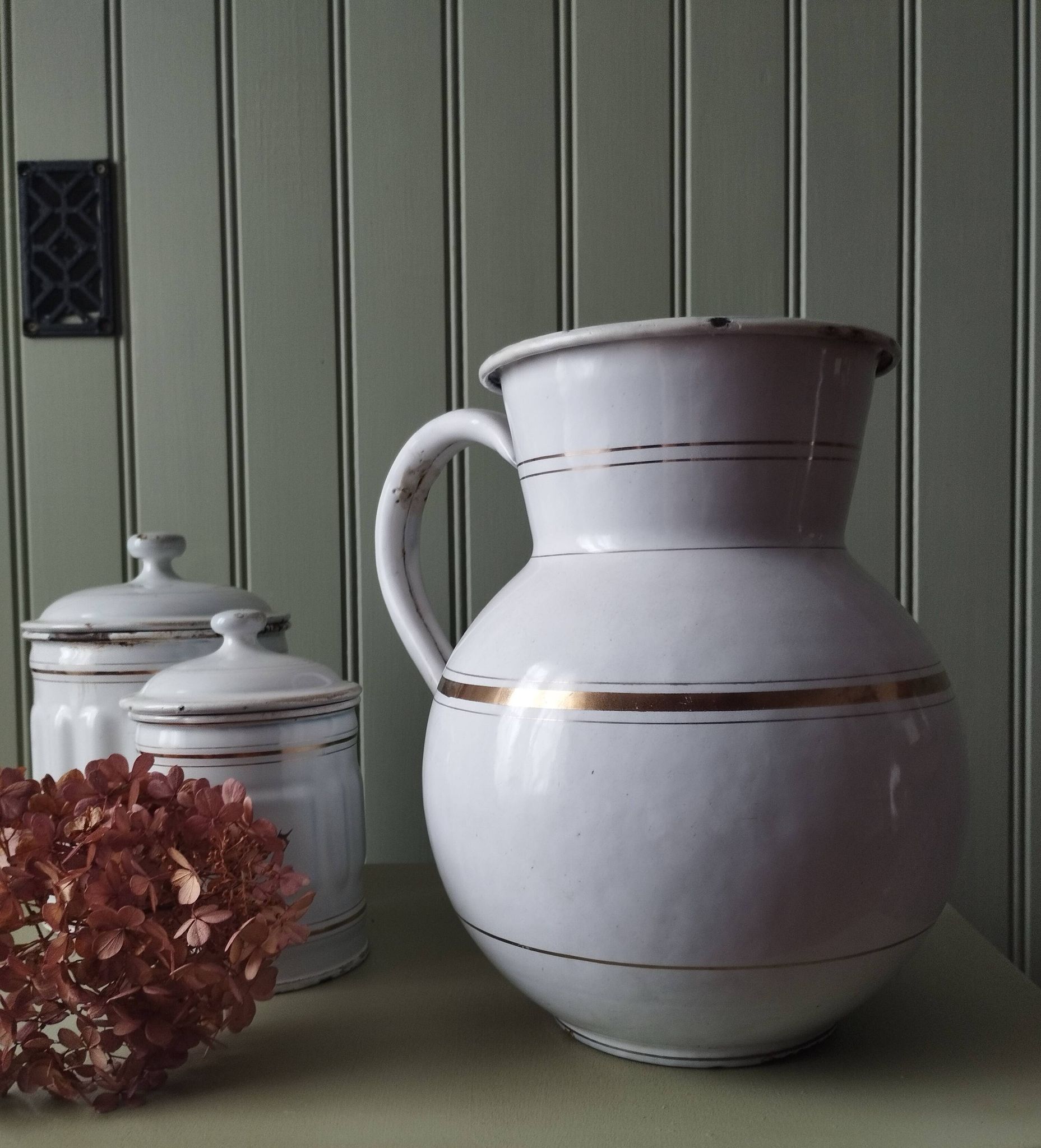 Rare large, pot-bellied toilet jug in white enamelled sheet metal with gold edging