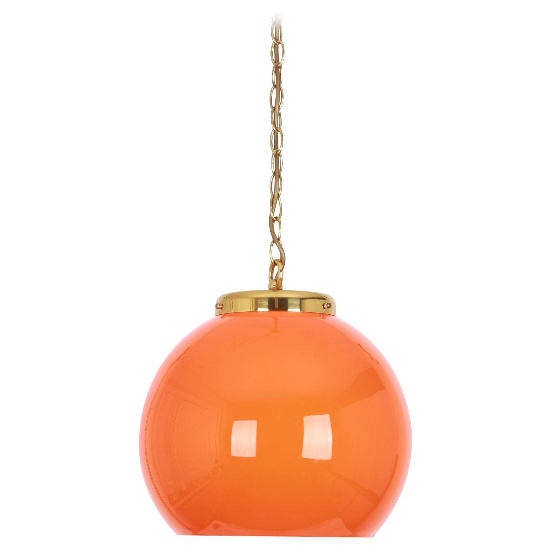 Orange glass pendant light by Peill Putzler, Germany, 1970.