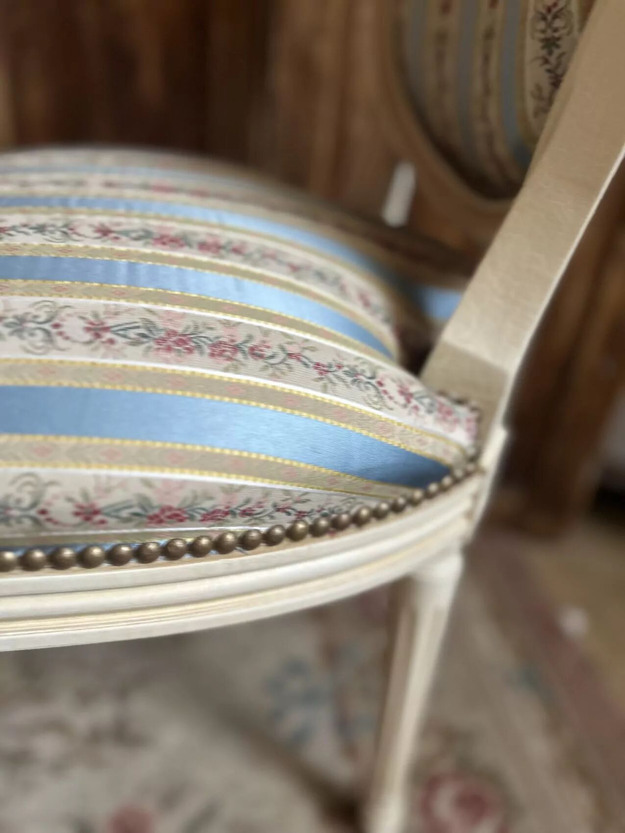 Pair of Louis XVI style chairs in painted wood and satin, classic elegance.