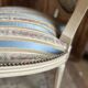 Pair of Louis XVI style chairs in painted wood and satin, classic elegance.