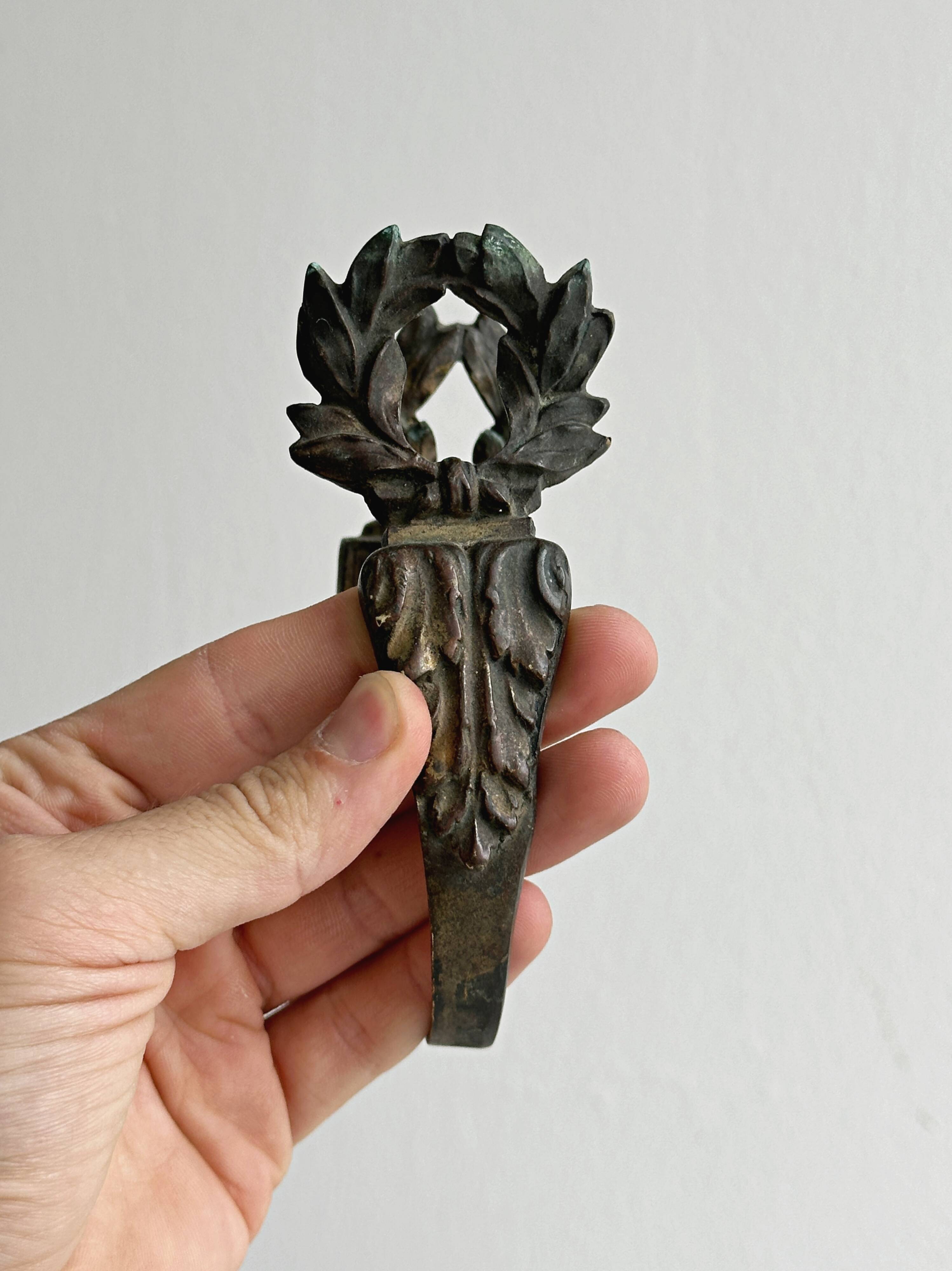 Antique black patinated metal coat hook.