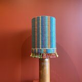 "Stoneware Bottle Lamp" with a multicoloured blue lampshade handwoven in India.