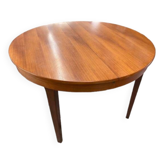 Round wooden table with integrated extensions