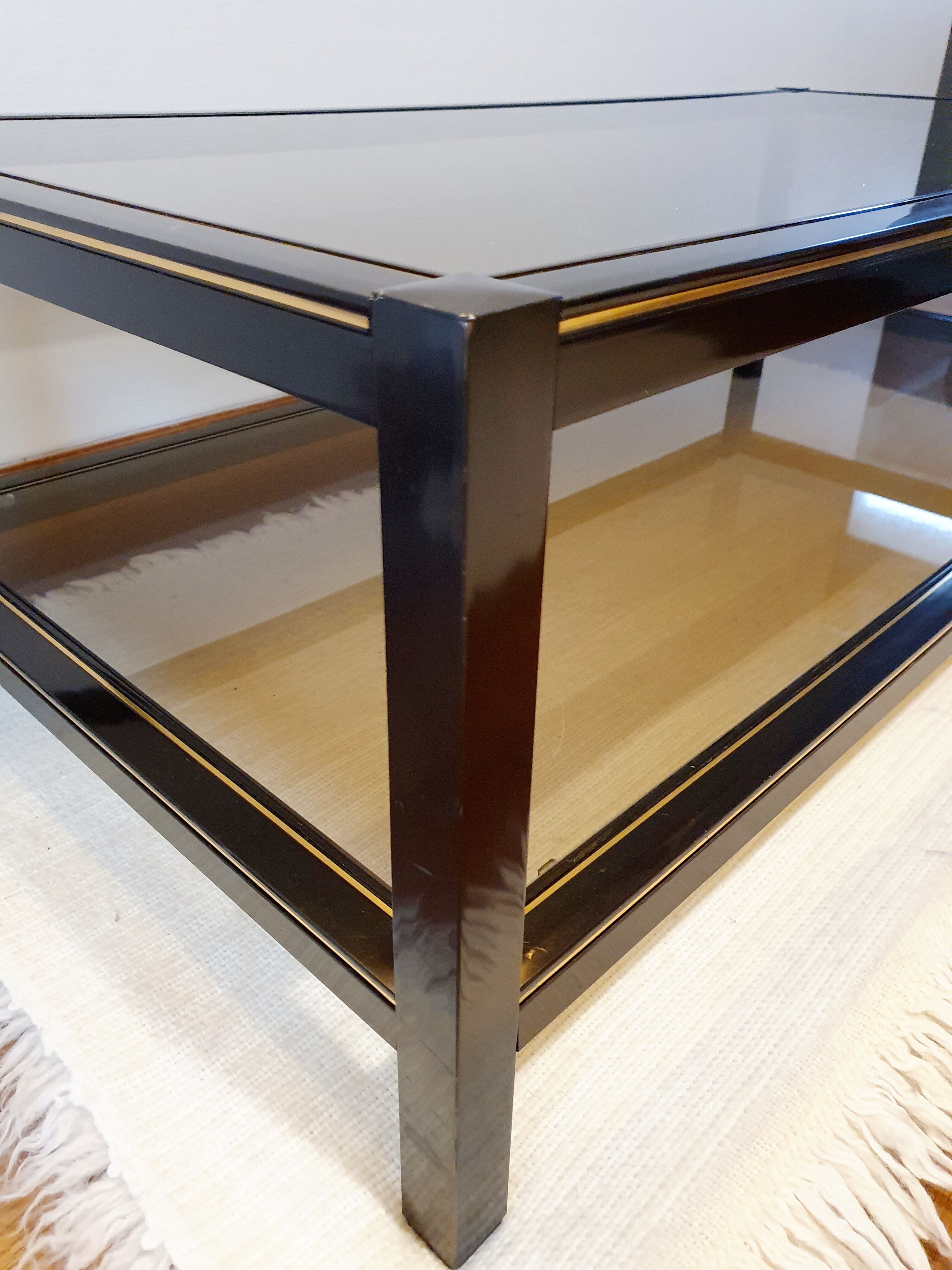Black and gold coffee table with a double smoked glass top