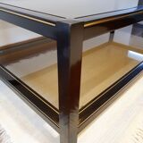 Black and gold coffee table with a double smoked glass top