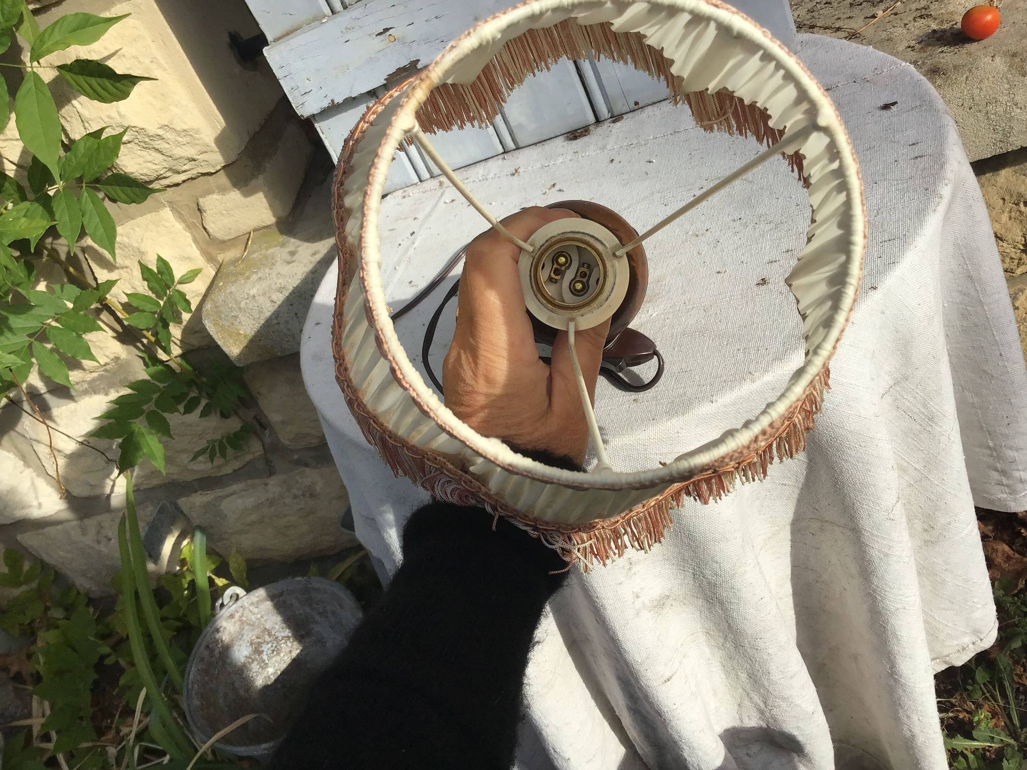 Turned wooden foot lamp with pleated lampshade