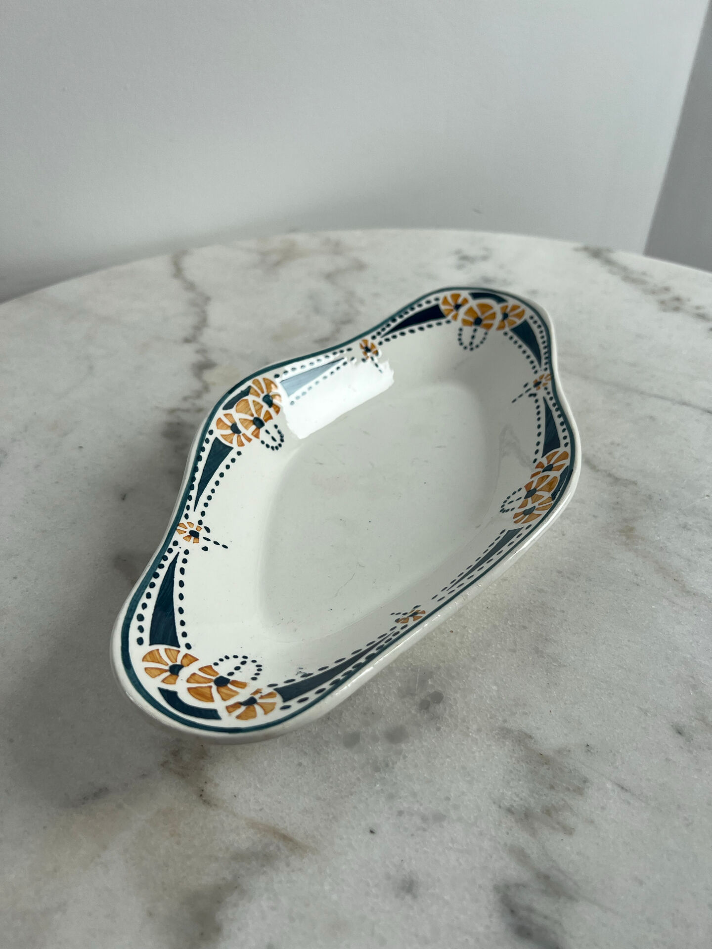 Longwy ramekin with blue and orange floral decoration.