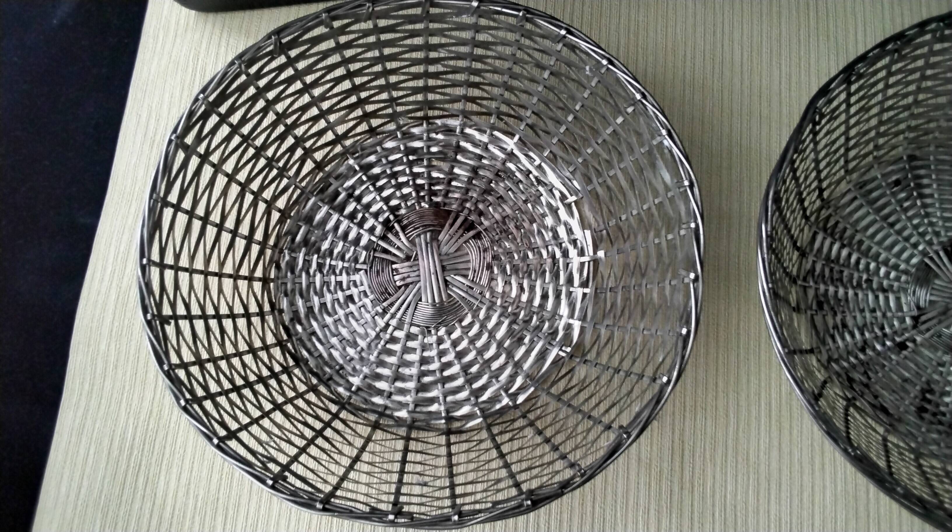 Pair of bread baskets, woven silver-plated wire baskets