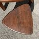 Nested tripod tables made of solid wood, in a modernist brutalist style.
