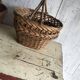 Set of 2 brown wicker baskets from the 1960s — decorative weaving and double handles.