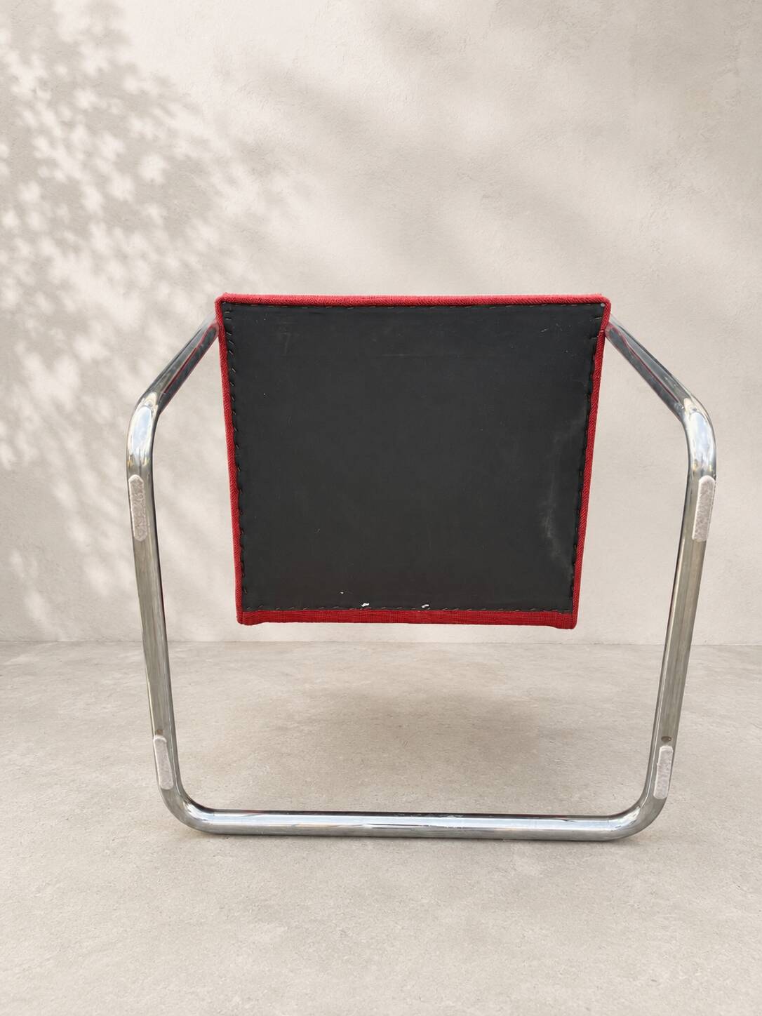 Vintage cantilever chair in chrome and burgundy fabric.