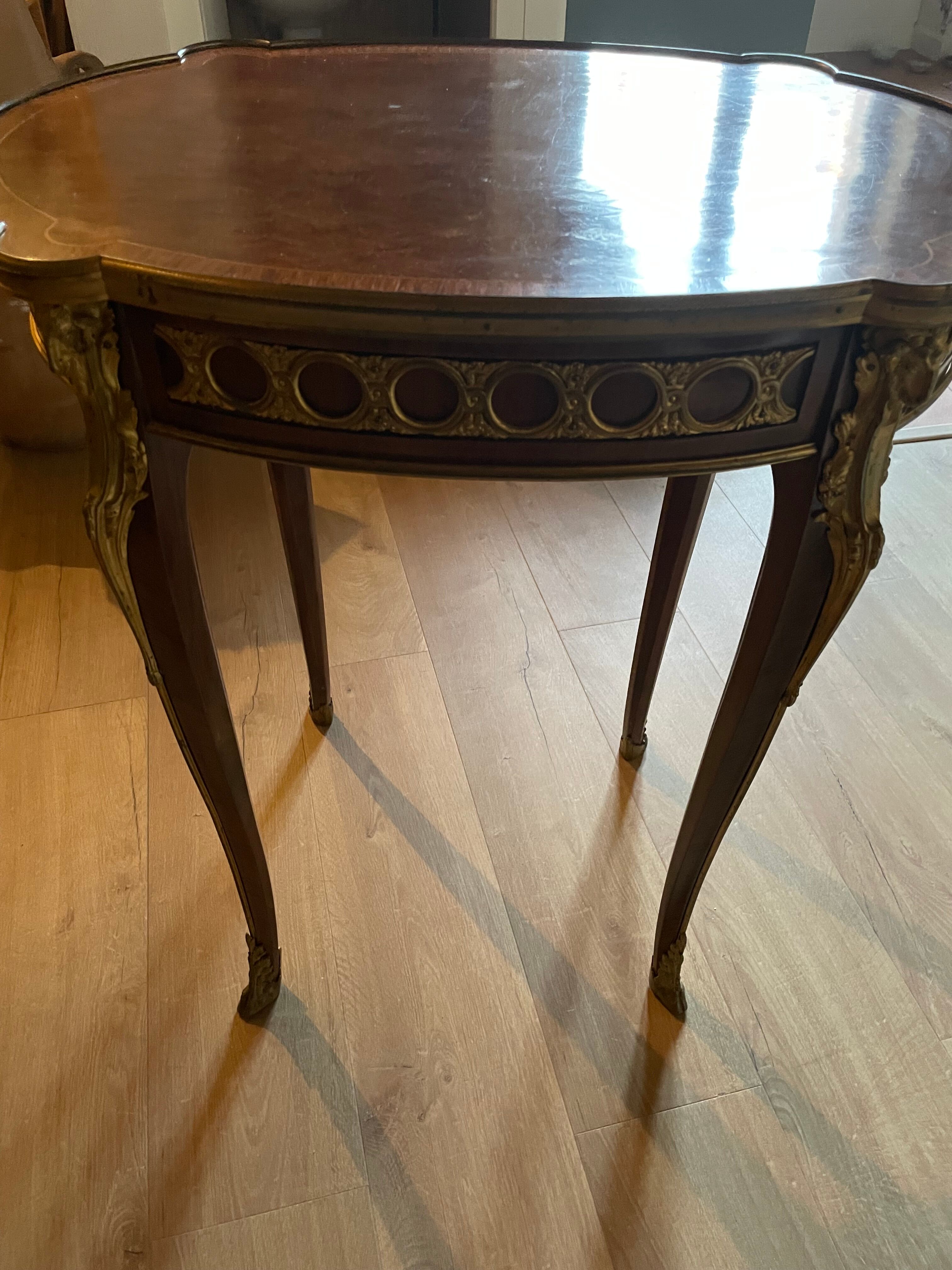 Living room table in Louis XV-Louis XVI transitional style with marquetry and bronze.
