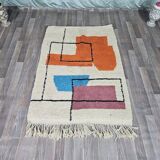 Traditional handmade wool Berber rug with colourful patterns.